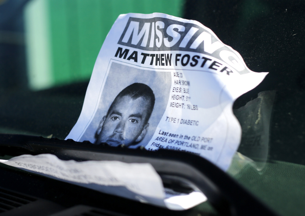 A missing person flier for Matthew Foster, 23, of Scarborough, missing since Friday, sits on the windshield of a vehicle on Widgery Wharf in Portland.
