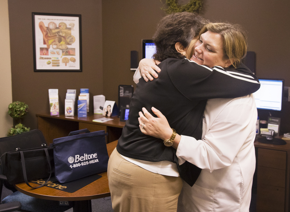 Pat Linhares, 75, of Old Orchard Beach, hugs specialist Karen Kirtani after being fitted for new hearing aids donated by Beltone in Scarborough.