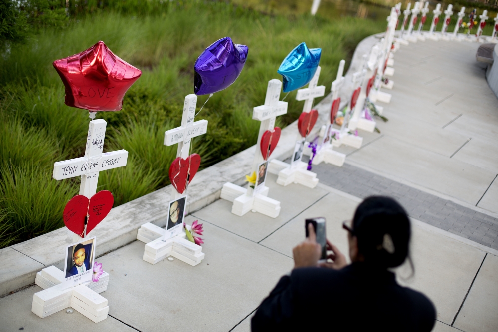 Crosses, one for each victim, line a walkway a few blocks from Pulse, the nightclub where a gunman killed 49 people Sunday morning. Experts say it's too soon to gauge whether a week of horrific news out of Orlando will hurt tourism there.