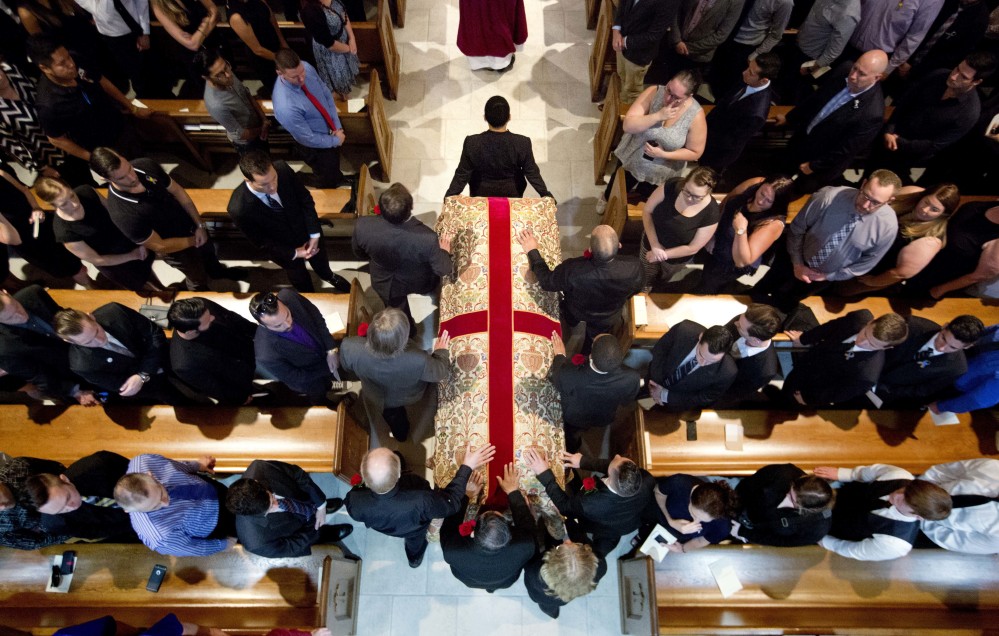 Pallbearers carry the casket of shooting victim Christopher Andrew Leinonen into the Cathedral Church of St. Luke for his funeral service Saturday in Orlando, Fla. Outside the church, hundreds lined the streets.