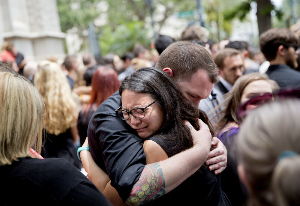 Mourners embrace after the funeral service for Christopher Andrew Leinonen, one of the victims of the Pulse nightclub mass shooting, outside the Cathedral Church of St. Luke on Saturday in Orlando, Fla.