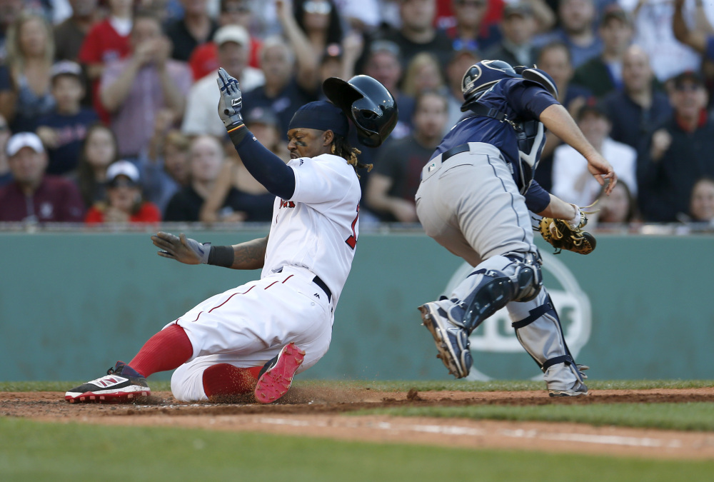 Hanley Ramirez slides into home to score from second on a throwing error ahead of the throw to Seattle catcher Steve Clevenger during the eighth inning of Boston's 6-2 win Saturday at Fenway Park.
