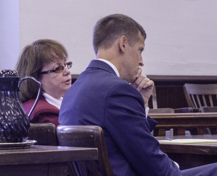 Claudia Viles speaks to her attorney, Walter McKee, during the prosecution's opening statement in her trial in Somerset County Superior Court on Monday.