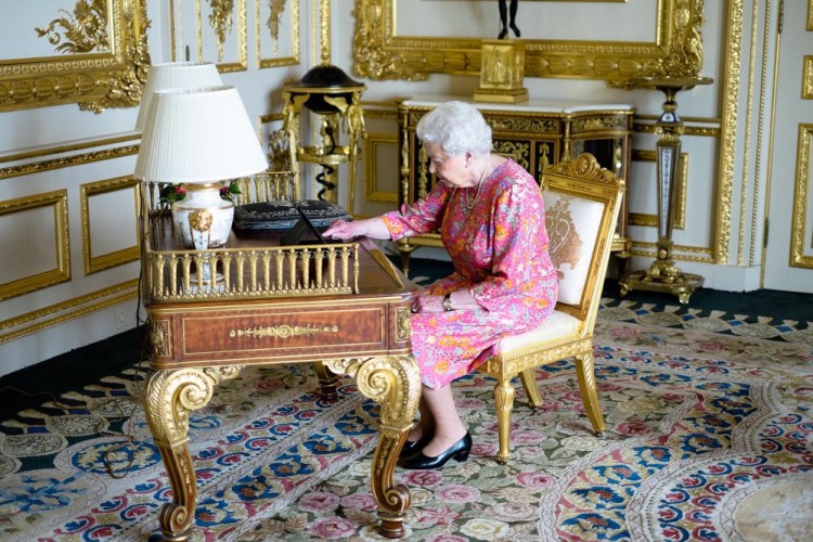 Britain's Queen Elizabeth II tweets on a tablet thanking everyone for their birthday messages in the Drawing Room in Windsor Castle, Windsor, England.