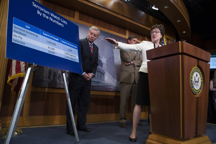 Sen. Susan Collins, R-Maine, accompanied by Sen. Lindsey Graham, R-S.C., left, and Sen. Martin Heinrich, D-N.M., behind Collins, uses a chart Tuesday to indicate the number of people who would be affected by her proposed "no fly, no buy" restriction on firearm sales.