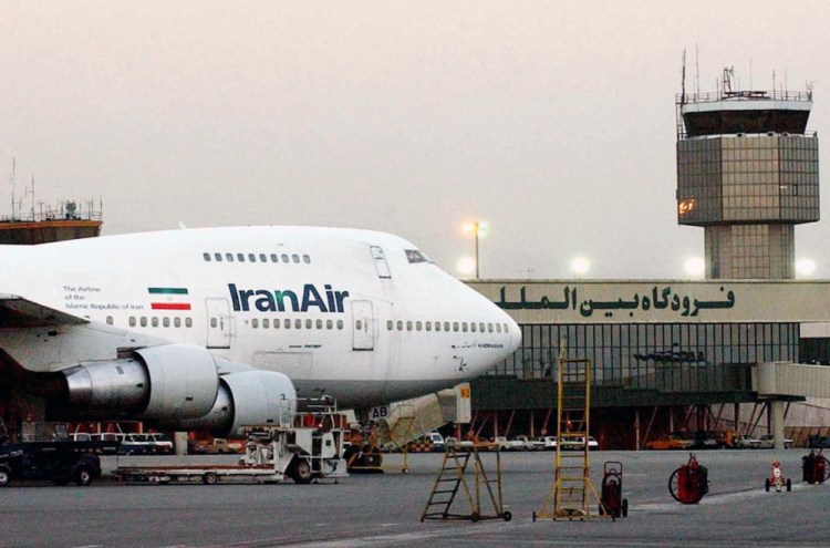 An Iran Air jet sits near the terminal at Mehrabad International Airport in Tehran in 2003. Boeing says the airline's deal of intent to buy the company's planes was authorized by the U.S. government "following a determination that Iran had met its obligations under the nuclear accord reached last summer."
