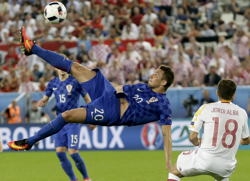 Marko Pjaca of Croatia goes for an overhead kick Tuesday during the Group D game against Spain at Bordeaux, France. Croatia won 2-1 and handed Spain its first loss at the every-four-years tournament since 2004.