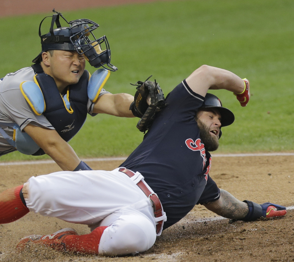 Mike Napoli of the Cleveland Indians is tagged out by Tampa Bay catcher Hank Conger while trying to score from second on a single. Cleveland won, 6-0.