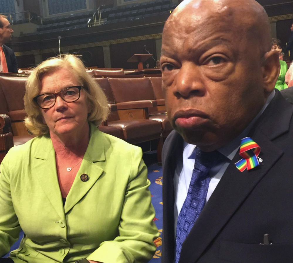 Maine Rep. Chellie Pingree sits with the Democrats' protest leader, Rep. John Lewis of Georgia, in the well of the House on Wednesday.
