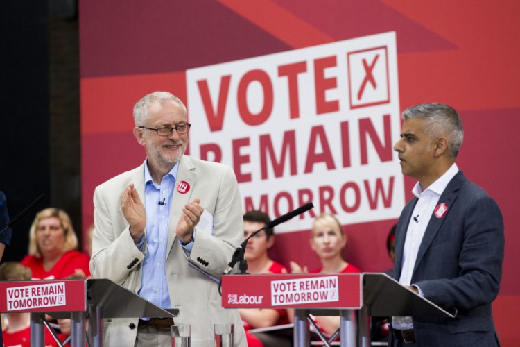 The leader of Britain's opposition Labour Party Jeremy Corbyn, left, applauds London mayor Sadiq Khan as he makes an address during a European Referendum "Remain" rally in London on Wednesday. Britain votes whether to stay in the European Union in a referendum on Thursday.