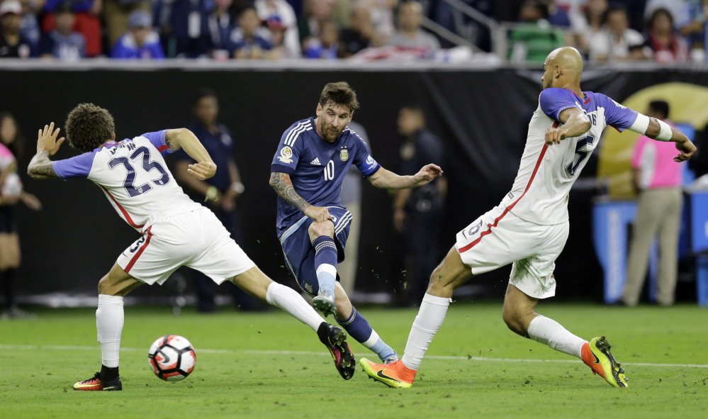 Argentina's Lionel Messi, center, scorches a shot on goal past Fabian Johnson, left, and Matt Besler of the United States during Argentina's 4-0 win in the Copa America Centenario semifinal at Houston on Tuesday.