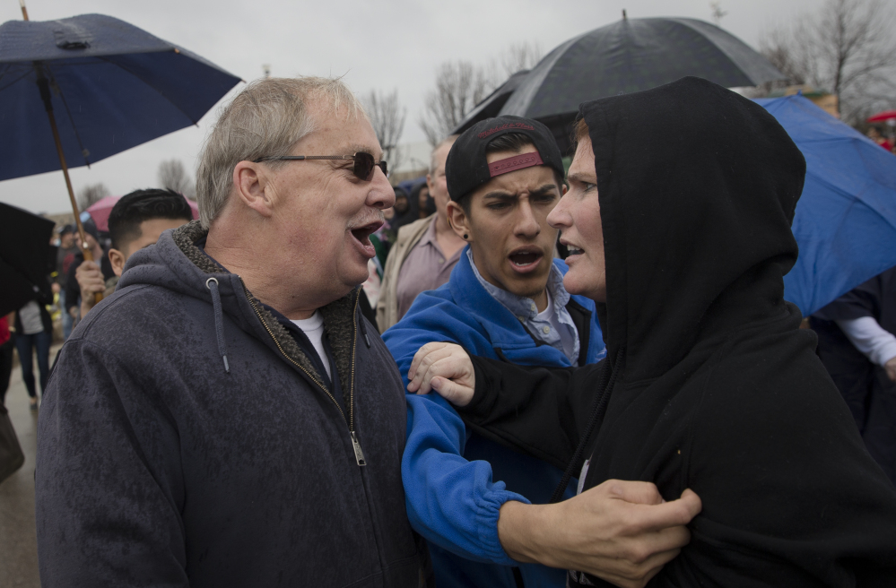 this Sunday, March 13, 2016 file photo, a supporter of Republican presidential candidate Donald Trump, left, and a protester argue before the candidate's arrival ahead of a campaign stop at the Savannah Center in West Chester, Ohio. Democratic and Republican views of the opposing political party have sunk to such lows that many say their rivals make them feel afraid, according to an opinion poll released by the Pew Research Center on Wednesday, June 22, 2016.