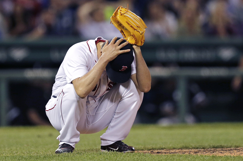 Associated Press/Charles Krupa
Red Sox reliever Koji Uehara grabs his head shortly after giving up a two-run home run to Chicago's Melky Cabrera, which tied the game at 6-6, in the eighth inning Wednesday night at Fenway Park.