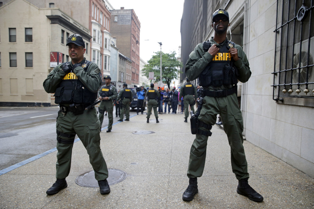 Members of the Baltimore City Sheriff''s Office stand guard outside a courthouse as they await the arrival of Officer Caesar Goodson, one of six Baltimore city police officers charged in connection to the death of Freddie Gray. y