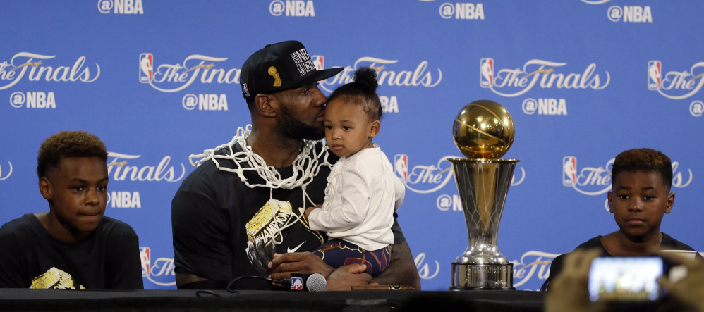 LeBron James, center, sits with his family for a post-game news conference after his Cavaliers won the NBA title on Sunday night. James said Thursday he plans to skip the Olympics in Rio.