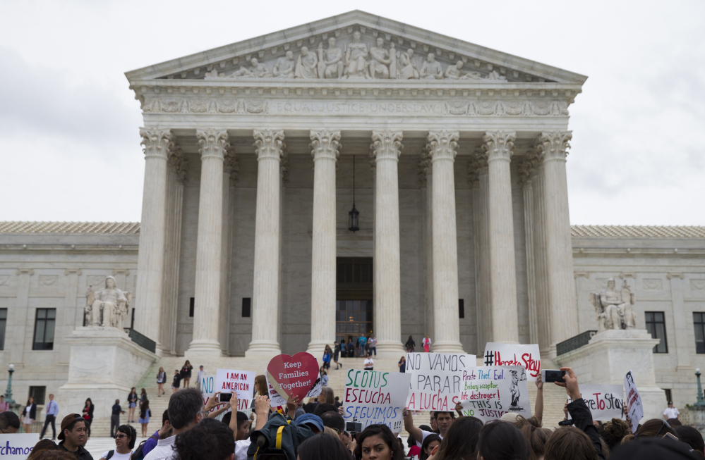 Demonstrators gather outside the Supreme Court in Washington on Thursday. A divided court upheld the University of Texas admissions program that takes account of race.