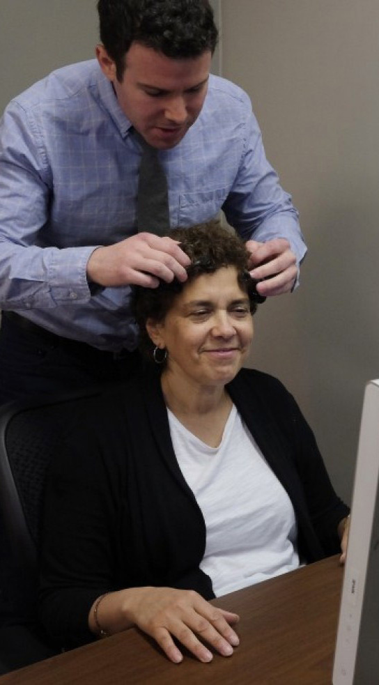 Neuroscientist Ryan McGarry prepares Jennie Litvack, 52, for research at Spark Experience in Maryland. Researchers found that what people feel and what they say they feel are rarely the same.
