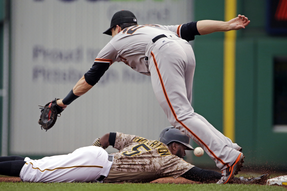 An errant pickoff attempt eludes San Francisco first baseman Buster Posey – a miscue that allowed Pittsburgh's Josh Harrison to reach third during a 5-3 Giants win Thursday at Pittsburgh.
