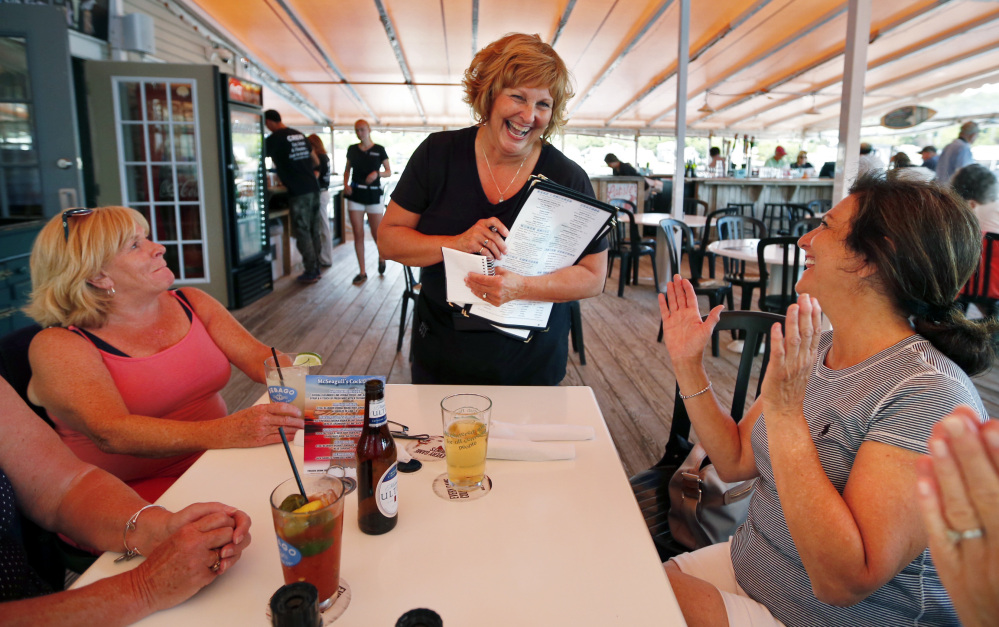 Ann LePage chats with diners after taking their order at McSeagull's restaurant in Boothbay Harbor on Thursday. The governor's wife says she doesn't tell customers or co-workers who she is unless they ask.