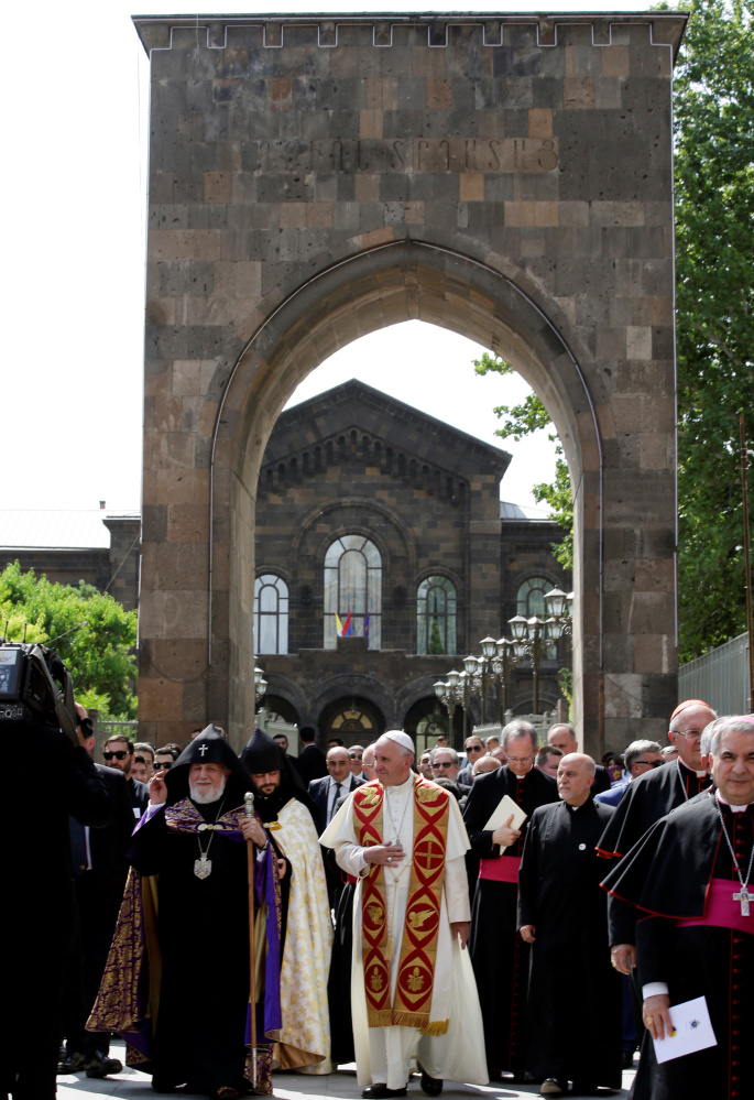 Pope Francis, center, and Catholicos of All Armenians Karekin II, left, arrive at the Apostolic Cathedral in Etchmiadzin, Armenia, on Friday. The visit marks the centenary of a massacre.