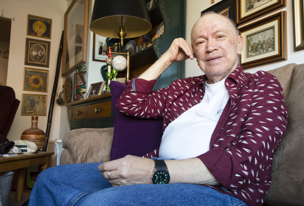 Michel Cadorette, 79, sits in his Portland apartment on Friday. He says he will vote for Democrat Hillary Clinton, but somewhat reluctantly. "There are issues with her that are a bit of a turn-off but I guess it's what they call the lesser of two evils at this point," he said.