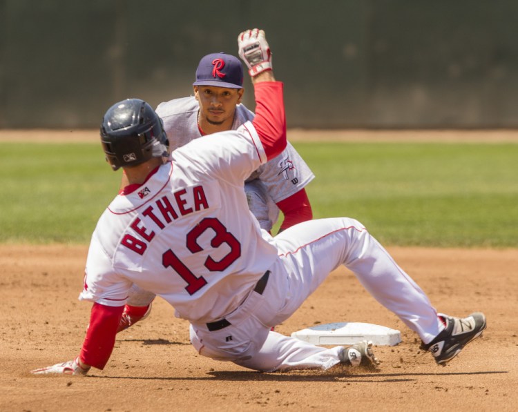 Portland's Danny Bethea slides late into second as Reading's Angelo Mora waits to place the tag at Hadlock Field in Portland on Sunday. 
 Carl D. Walsh/Staff Photographer