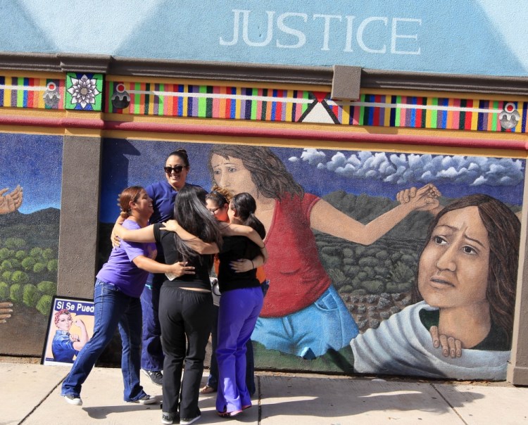 Staff members of Whole Woman's Health celebrate in front of a mural on the side of the building in McAllen, Texas, after the Supreme Court ruling against Texas' abortion restrictions Monday. Whole Woman's Health is an abortion provider that stayed open.
