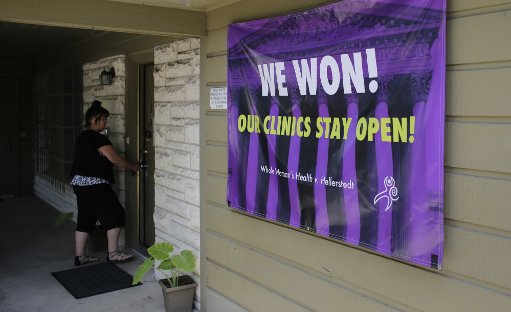 A poster put up Monday at the Choice Clinic, formerly Whole Woman's Health Clinic, in Austin, Texas, hails a historic ruling that strikes down one of the most restrictive state abortion laws in the U.S.
