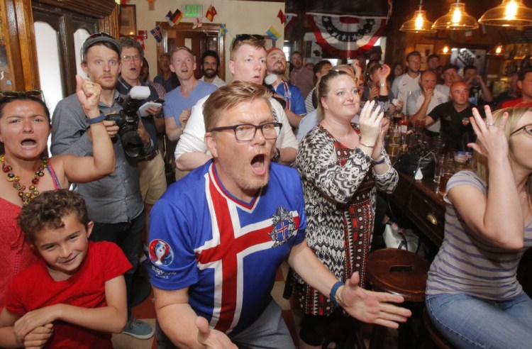 Petur Petersen, center, and others react at Ri Ra, a Portland pub, during Iceland's victory Monday over England. They'll be cheering again Sunday in the quarterfinals against France.