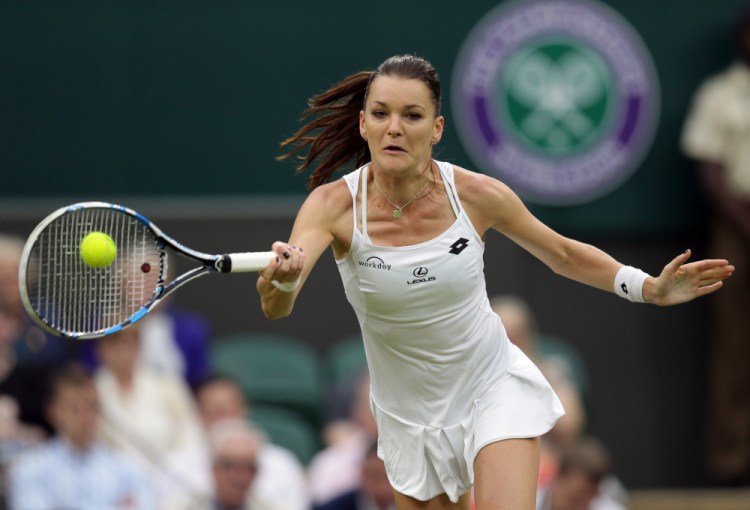 Agnieszka Radwanska returns to Kateryna Kozlova during their women's singles match on day three of Wimbledon in London Wednesday.