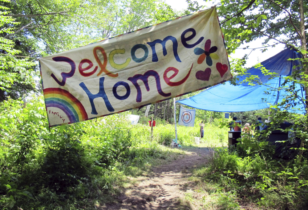 A sign welcomes people to the gathering of the Rainbow Family of Living Light in Mount Tabor, Vt. The decades-old get-together is held each year on national forestland.