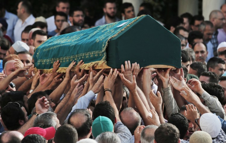 Mourners in Istanbul on Wednesday carry the coffin of Muhammed Eymen Demirci, 25, who was killed Tuesday at Istanbul's Ataturk Airport.