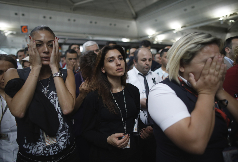 Family members, colleagues and friends of the victims of Tuesday's blasts gather for a memorial ceremony at the Ataturk Airport in Istanbul, on Thursday.