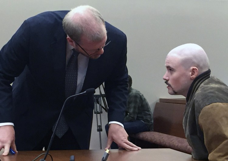 Attorney Scott Hess confers with his client, Leroy Smith III, during a hearing. The defense maintains Smith is not competent to enter a plea or stand trial on the charge of killing his father.