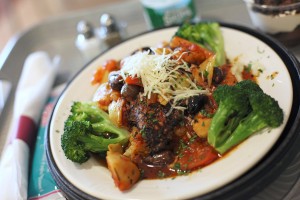 Mediterranean Chicken Saute is made with herb-coated chicken breast, artichokes, black olives and diced tomatoes, sauteed with white wine and served over risotto with broccoli on the side at Mercy Hospital. 