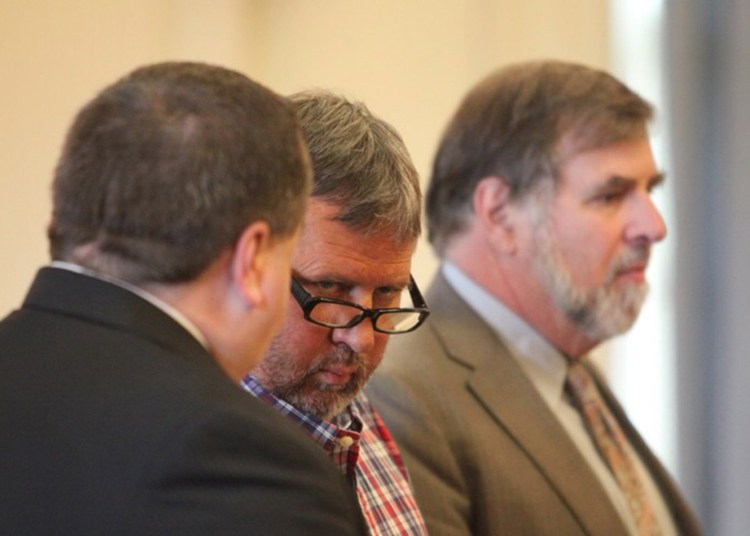 Bruce Akers, 57, of Limington, center, makes his initial appearance at York County Superior Court in Alfred center, on June 13, 2016, on a charge of murdering his Ossipee Trail neighbor, 55-year-old Douglas Flint. At left is attorney Robert LeBrasseur and at right is attorney Paul Aronson.
