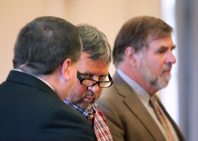 Bruce Akers, 57,  of Limington, center, who pleaded not guilty Tuesday on a charge of murdering his neighbor Douglas Flint, is shown in his initial appearance in York County Superior Court on June 13, 2016. At left is attorney Robert LeBrasseur and at right is attorney Paul Aranson.