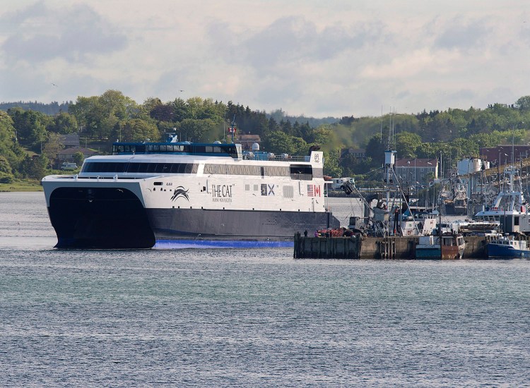 The Cat, a high-speed passenger ferry, departs Yarmouth, Nova Scotia, heading to Portland, Maine, on its first scheduled trip last year. The vessel, expected to boost tourism in Nova Scotia, is chartered by Bay Ferries Ltd. from the U.S. Navy's Military Sealift Command and is crewed by Americans. 