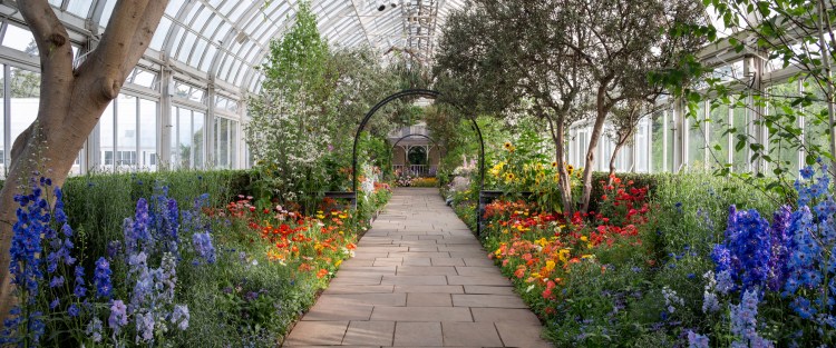 A Colonial-era "grandmother's garden" is planted around the facade of a house inside the Botanical Garden's Enid A. Haupt Conservatory in New York. The garden was the type favored by American Impressionist painters.    New York Botanical Garden via AP/Robert Benson/
