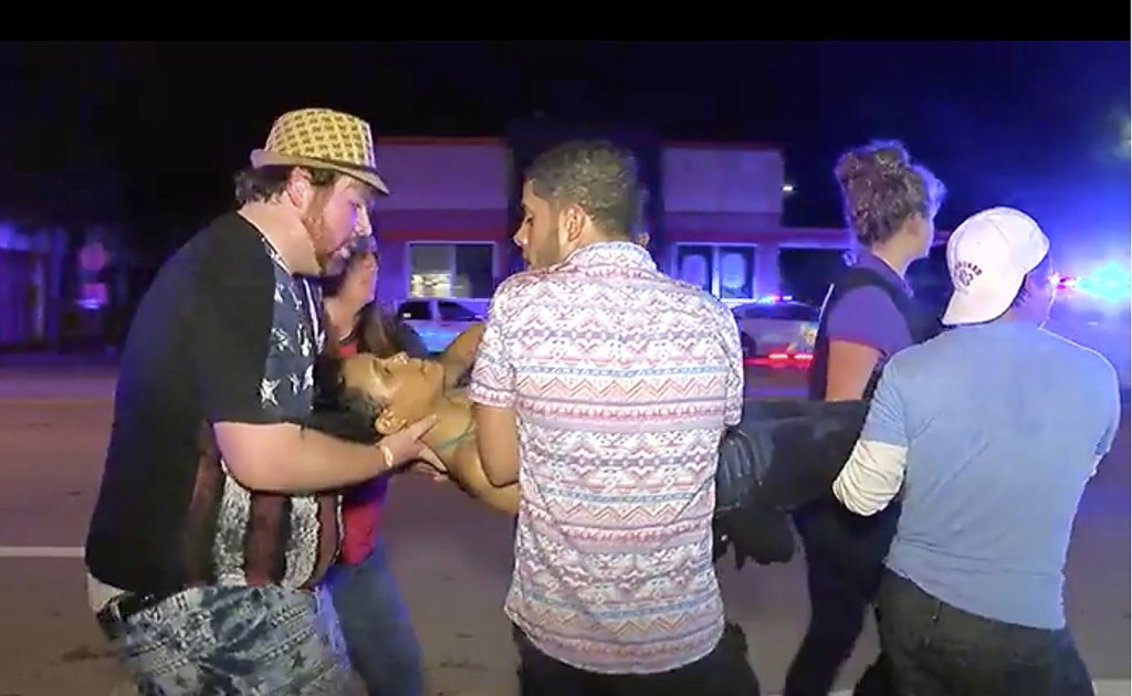 A shooting victim is carried out of the Pulse nightclub Sunday morning in Orlando, Fla. Hundreds of young people had packed into the club for a dance party that was winding down when the shooting started.