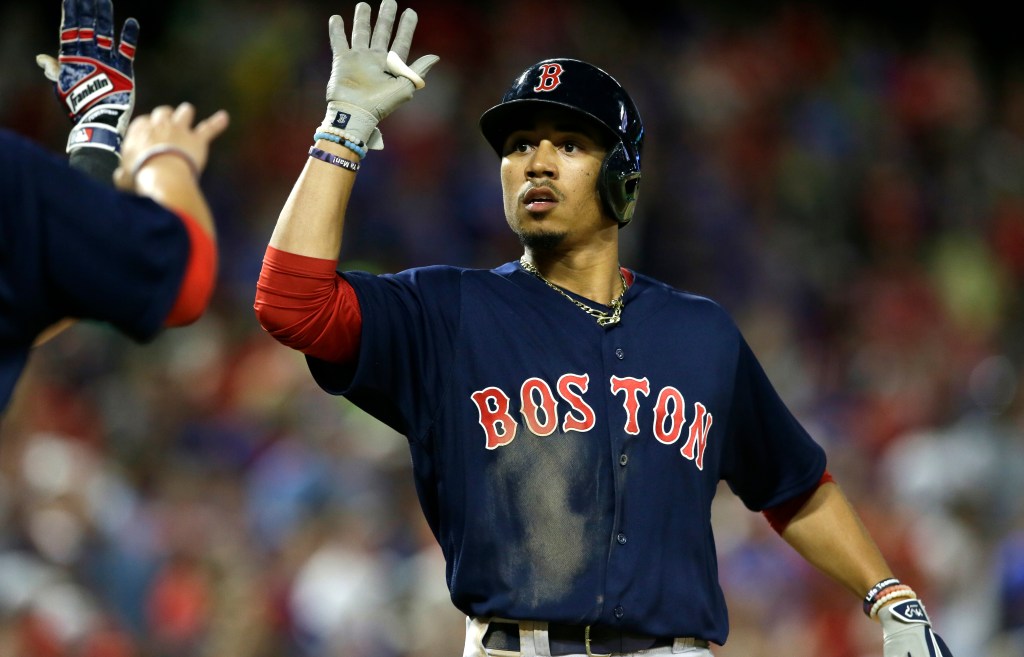Mookie Betts celebrates his home run during the ninth inning against the Rangers in Arlington, Texas, on Friday. The Red Sox won 8-7. 
AP Photo/LM Otero