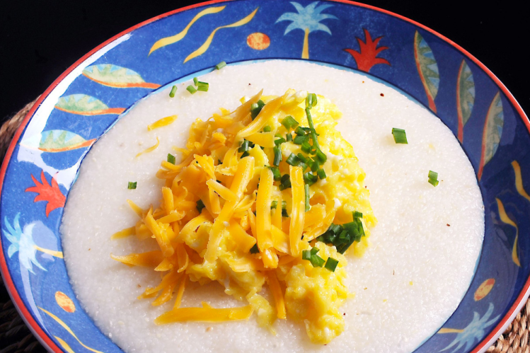 Cheddar, chives and eggs add some spice to grits.   The Associated Press