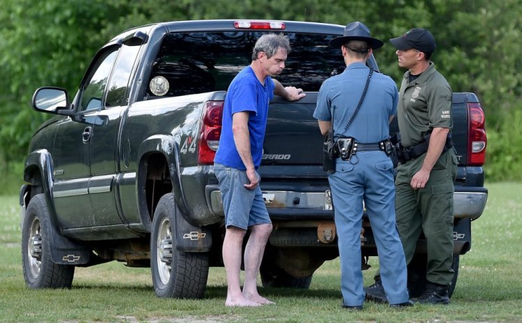 A game warden and a state trooper talk to Jeffrey Smith of Norridgewock, who was ejected from a motorboat on the Kennebec River along with Barbara York of Waterville on Thursday. York drowned, though Smith attempted life-saving efforts on her, according to a news release from the Department of Inland Fisheries and Wildlife.