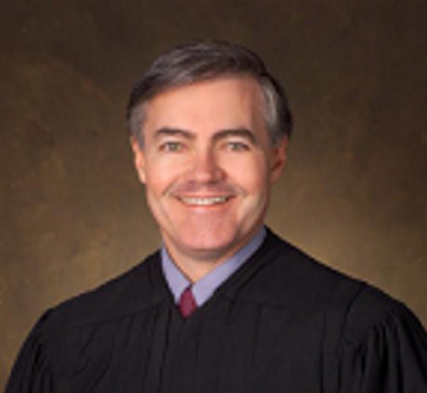 U.S. District Court Judge John A. Woodcock Jr. is moving to senior status, which will create a vacancy on the federal bench in Maine, the court announced Thursday.