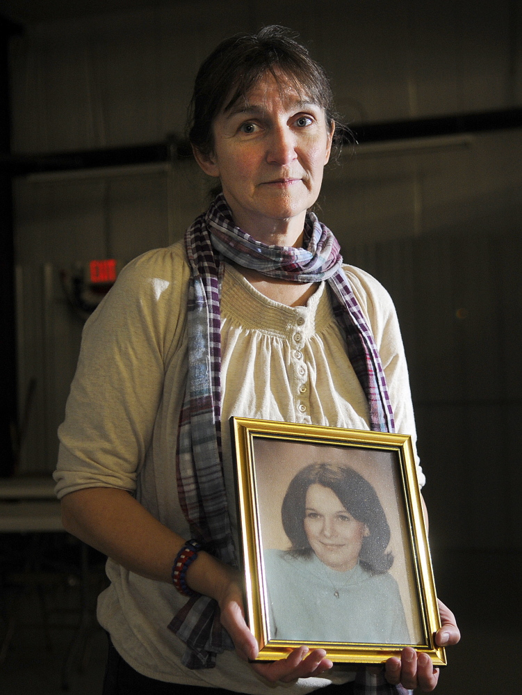 West Gardiner resident Vicki Dill holds a photo of her murdered sister, Debra Dill, in this 2013 file photo. Michael Boucher was convicted in 1991 for beating Debra Dill, 18, to death in 1973 with a hammer in Litchfield.