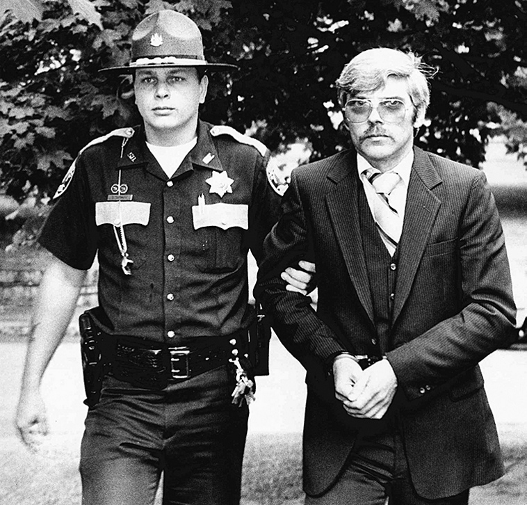 Michael Boucher, right, is escorted by Kennebec County Sheriff's Deputy Eric Testerman in this file photo from July 9, 1991.