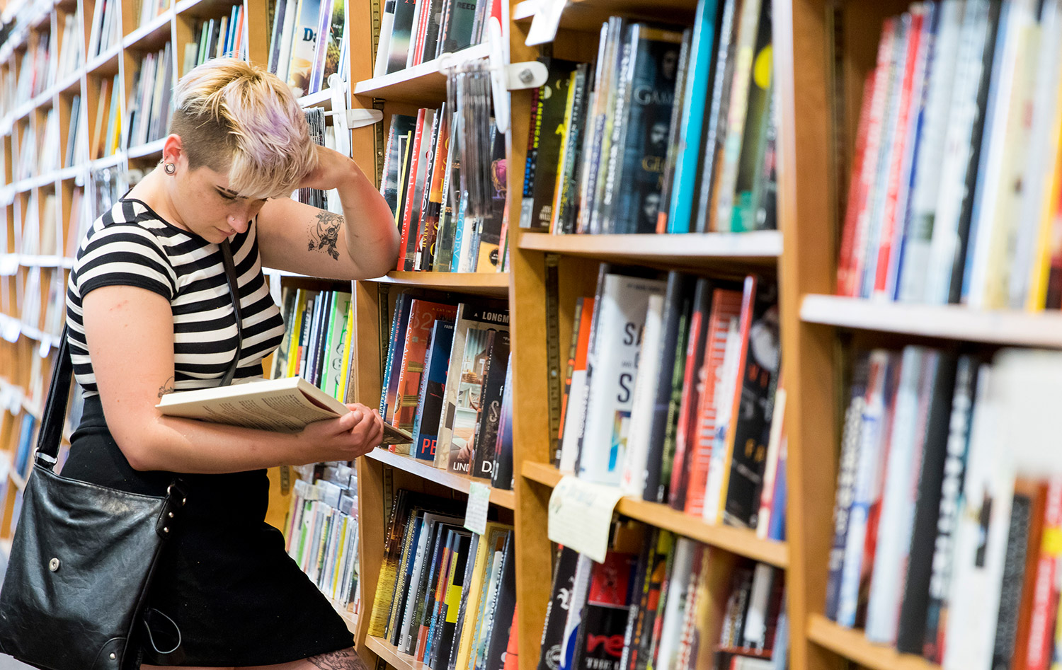 Riley Saladino of Portland flips through a book at Sherman Books on Exchange Street.