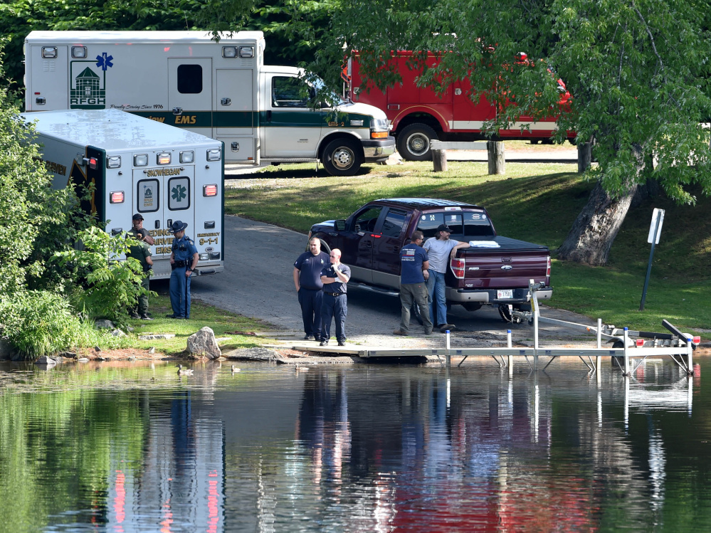 Paramedics from Redington-Fairview General Hospital, state troopers and wardens from the Maine Warden Service stand by the dock at the Oosoola Park boat landing as a crew searches for a drowning victim Thursday in the Kennebec River in Norridgewock. Barbara York was pronounced dead at the scene.