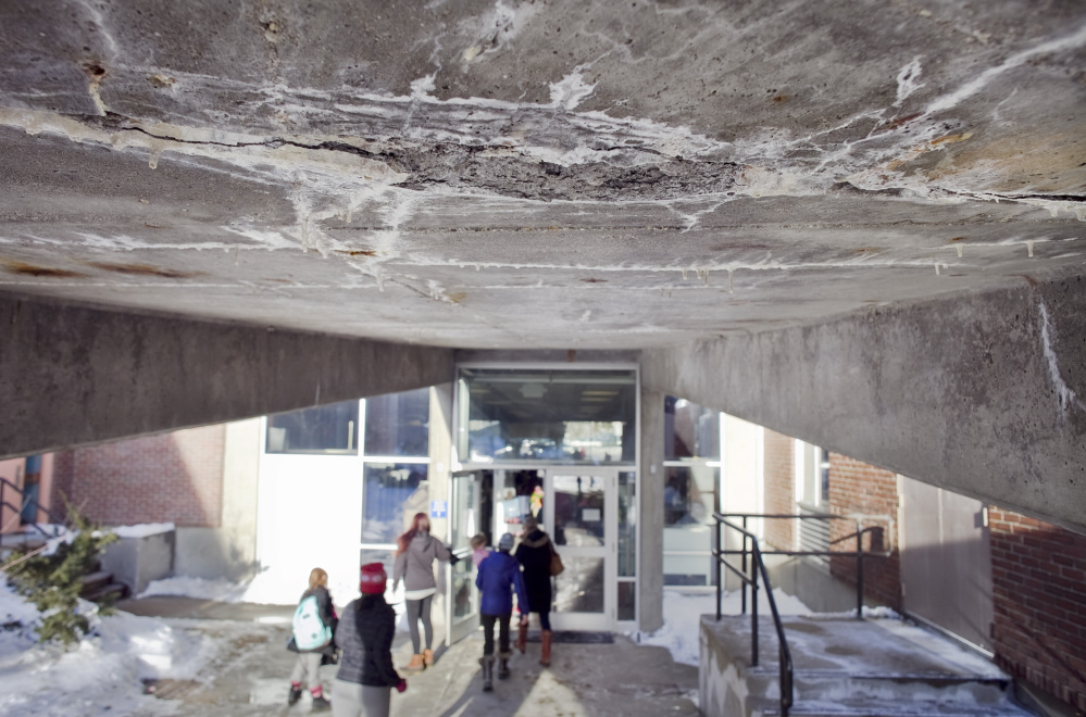 A section of crumbling concrete on the underside of a ramp at the Howard C. Reiche Community School in Portland gives a sense of the amount of deferred maintenance in the city's elementary schools.