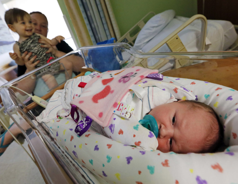 Amanda Fielding and her daughter Briella Debonise, 20 months, take a closer look at Braylin Debonise, 9 days old, at St. Luke's Hospital in New Bedford, Mass. Both of Fielding's daughters were born with an addiction to methadone.